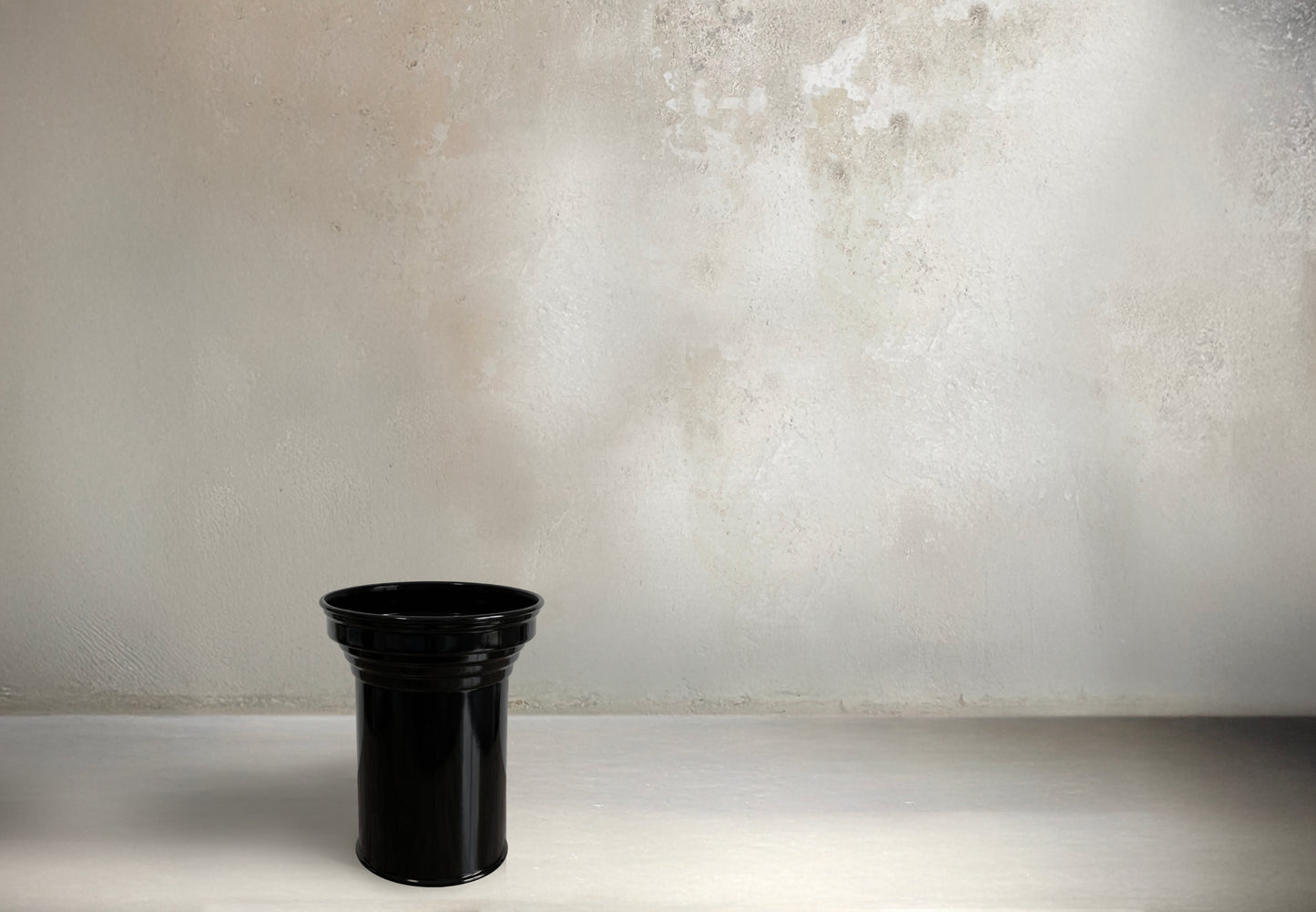 Sculptural column coffee table in glossy black metal