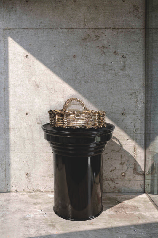 Black glossy column coffee table in contemporary interior design