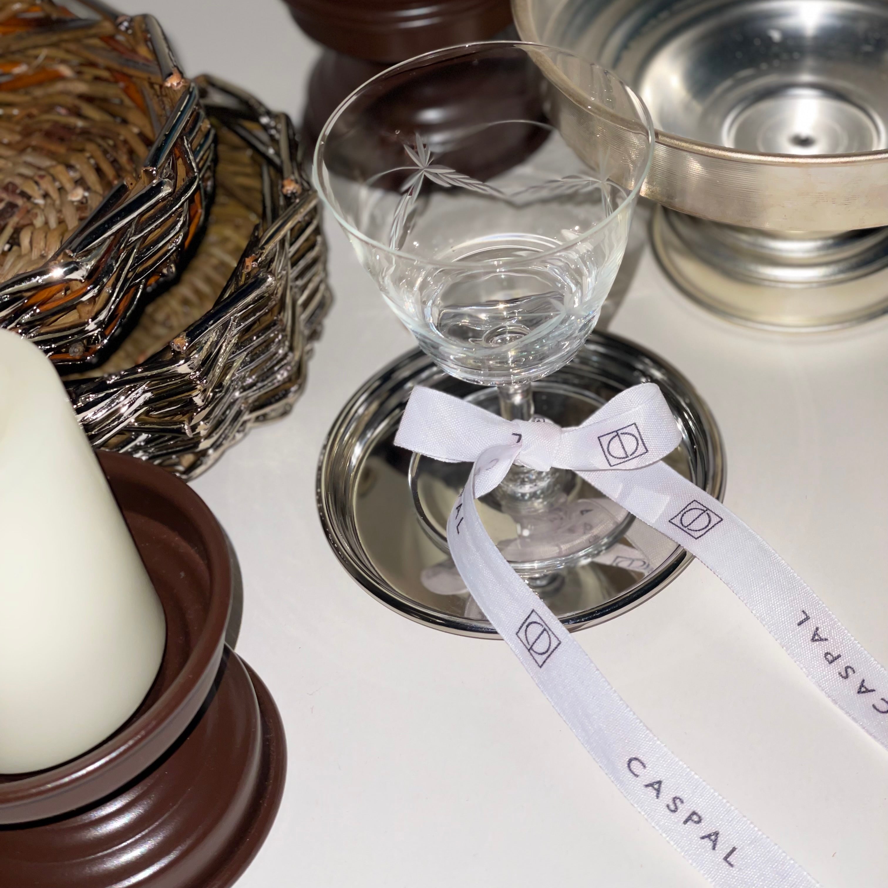 Elegant table setting with silver centerpiece and chocolate matt candle holders for refined dining decor
